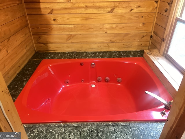 interior details with a tub to relax in and wood walls