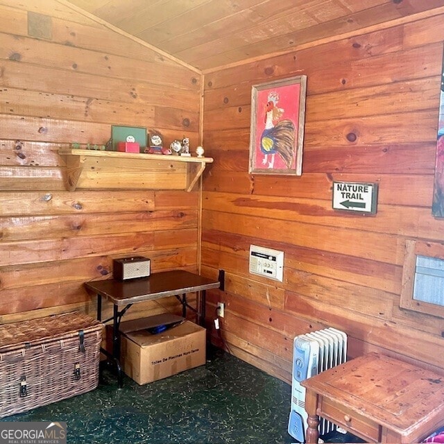 interior space featuring wooden walls and vaulted ceiling