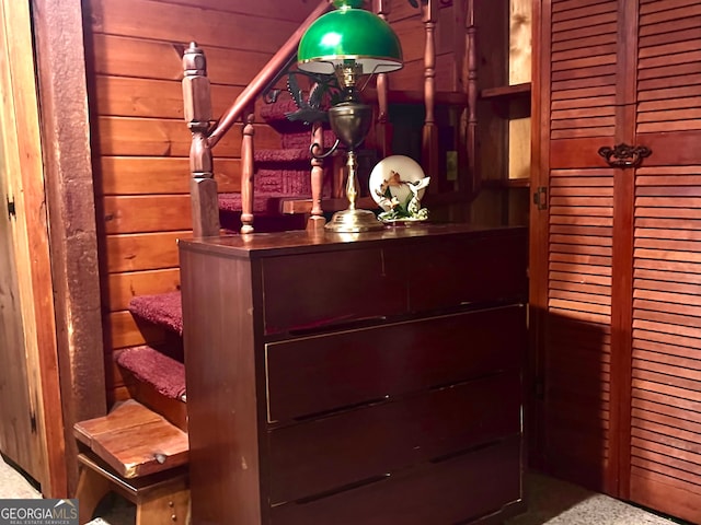 interior details with carpet flooring and wood walls