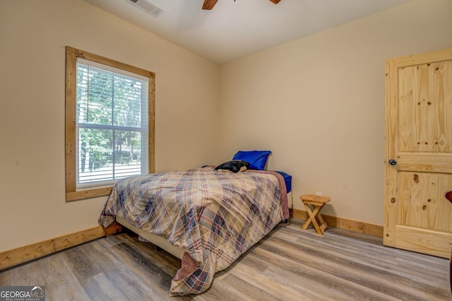 bedroom with hardwood / wood-style floors and ceiling fan