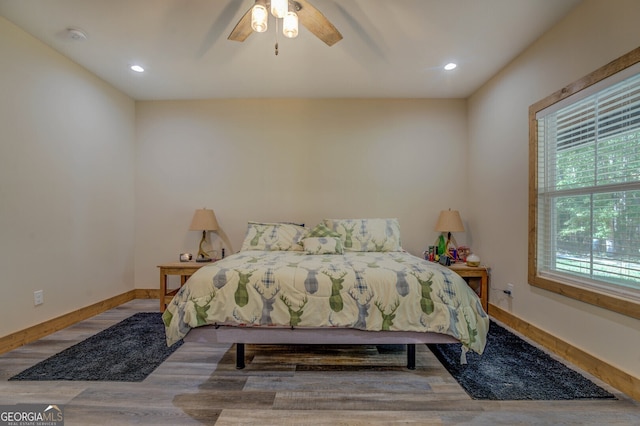 bedroom with wood-type flooring and ceiling fan