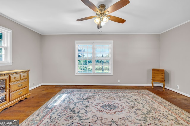 interior space featuring crown molding, dark hardwood / wood-style floors, and ceiling fan