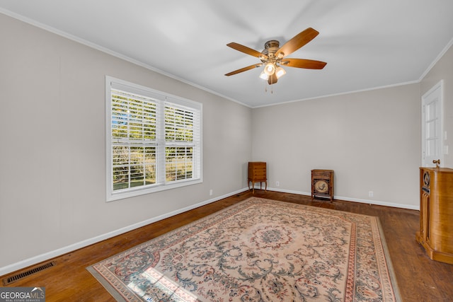 empty room with ceiling fan, ornamental molding, and dark hardwood / wood-style flooring