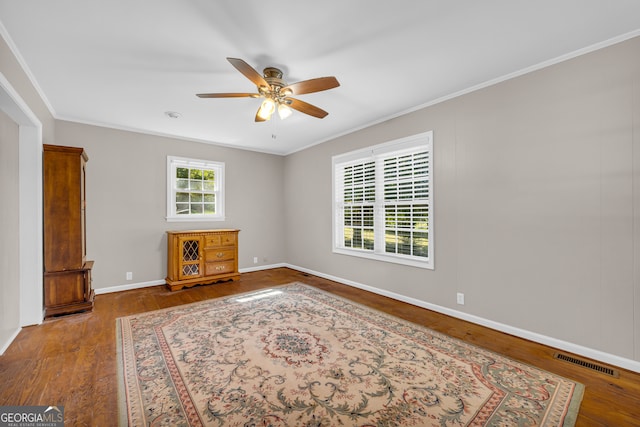 unfurnished room with ornamental molding, hardwood / wood-style flooring, and ceiling fan