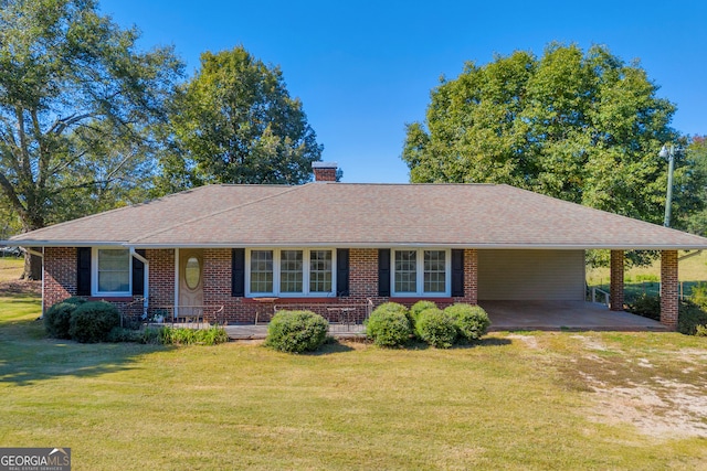 ranch-style house with a front yard and a carport