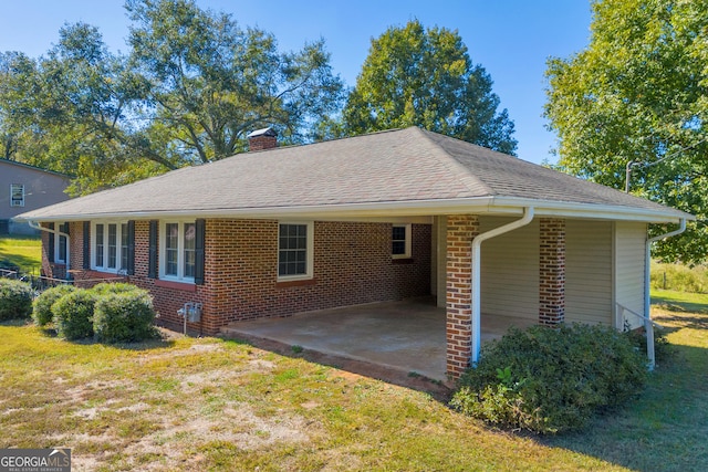 view of home's exterior featuring a yard and a carport