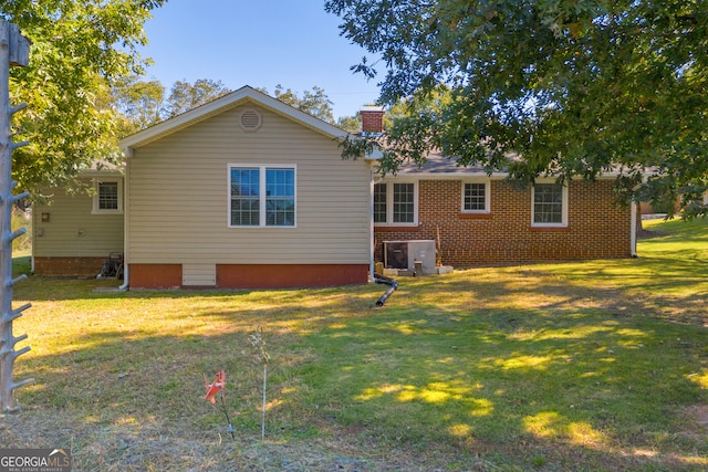 back of property featuring a lawn