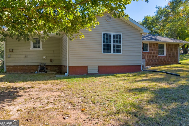 view of side of property with a yard