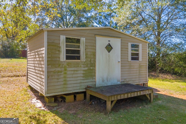 view of outbuilding featuring a lawn