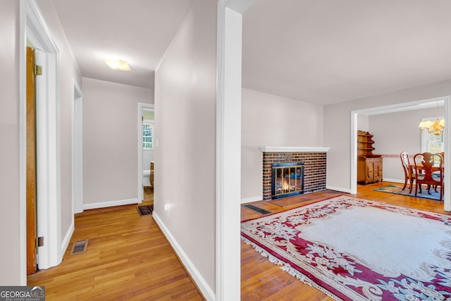 hallway with hardwood / wood-style flooring