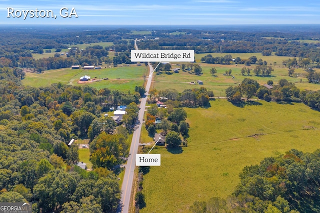 birds eye view of property with a rural view