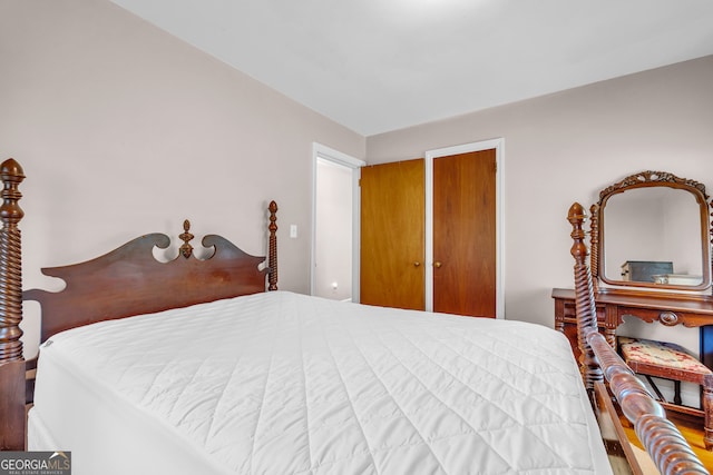 bedroom with a closet and hardwood / wood-style floors