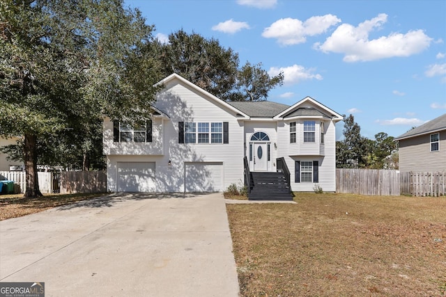 bi-level home featuring a front lawn and a garage