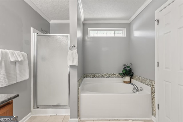 bathroom featuring tile patterned floors, plus walk in shower, ornamental molding, vanity, and a textured ceiling