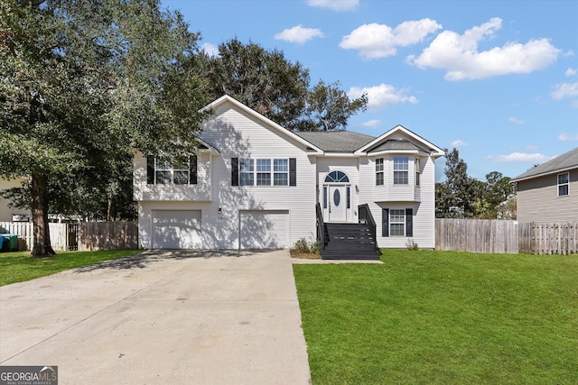 raised ranch with a front yard and a garage