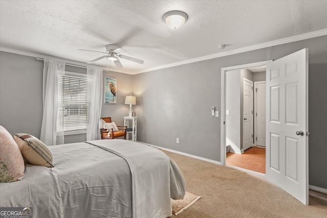 bedroom featuring ornamental molding, a textured ceiling, light colored carpet, and ceiling fan