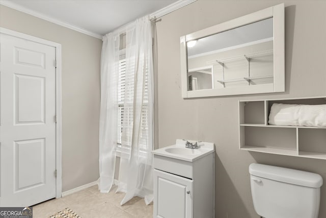 bathroom with vanity, ornamental molding, toilet, and tile patterned flooring