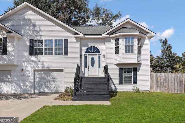 split foyer home featuring a garage and a front lawn