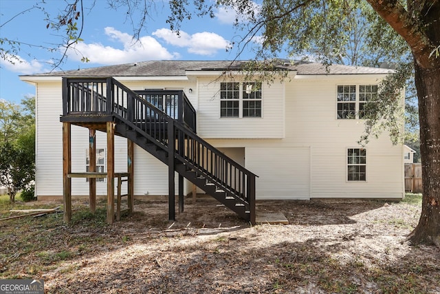 rear view of property featuring a wooden deck