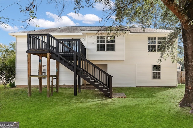 rear view of property with a wooden deck and a yard