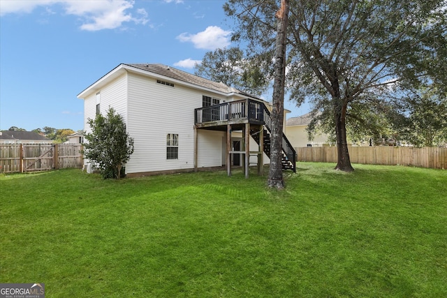 back of house with a yard and a deck