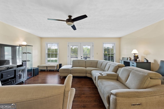 living room featuring dark hardwood / wood-style flooring, ceiling fan, french doors, and a textured ceiling