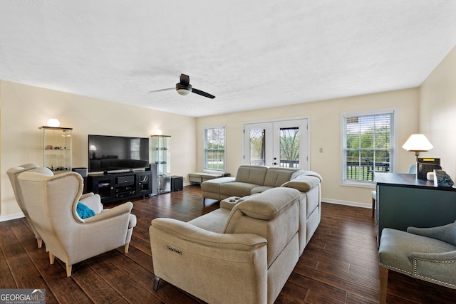 living room featuring dark wood-type flooring, ceiling fan, french doors, and a textured ceiling