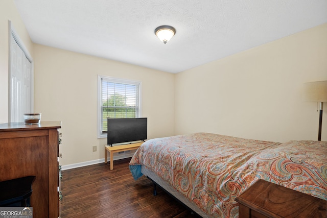 bedroom with dark hardwood / wood-style flooring