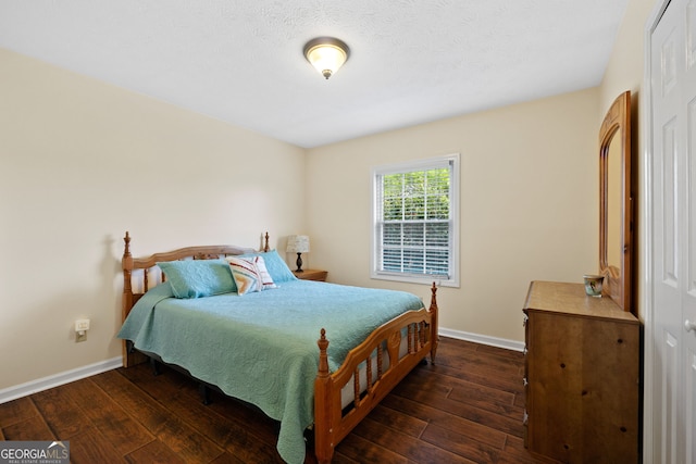 bedroom with dark hardwood / wood-style floors