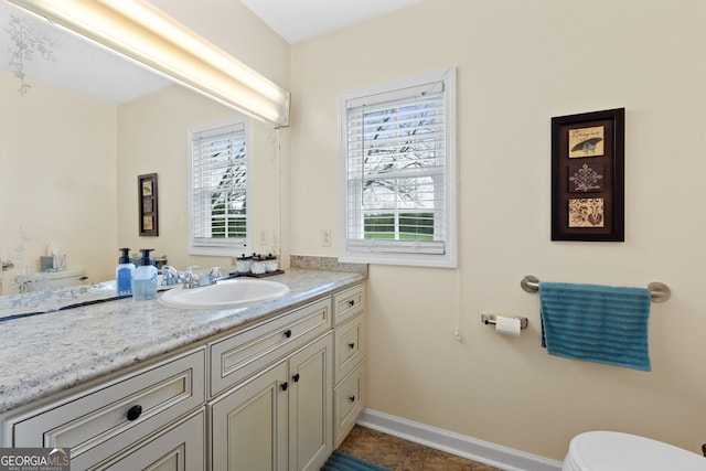 bathroom with vanity, tile patterned floors, and toilet