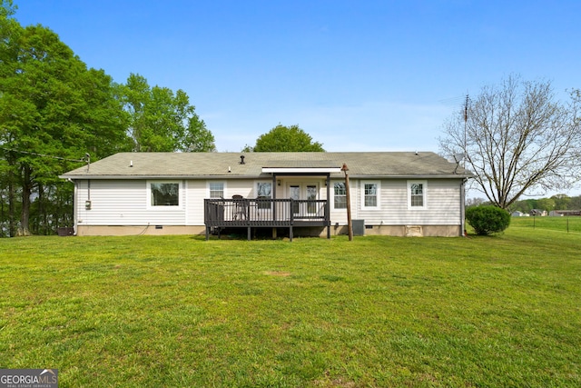 back of property with a yard, cooling unit, and a deck