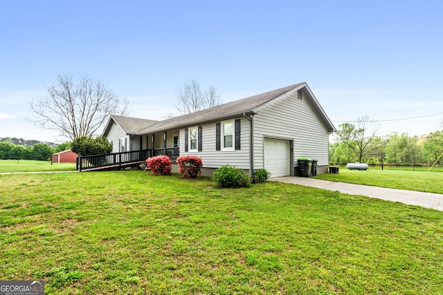 view of side of property featuring a wooden deck, a garage, and a yard