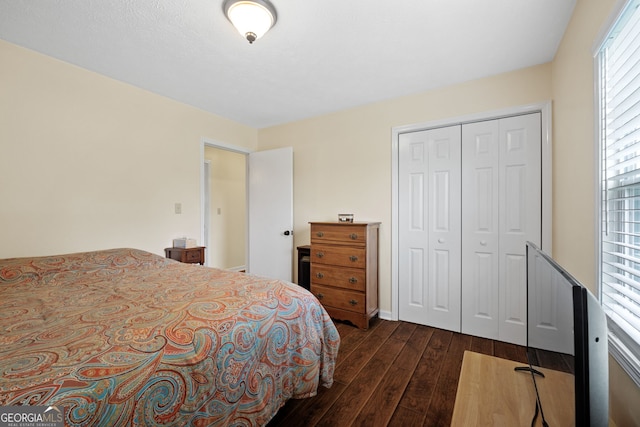 bedroom with a closet and dark hardwood / wood-style floors