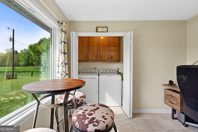 laundry area featuring washer and dryer and cabinets