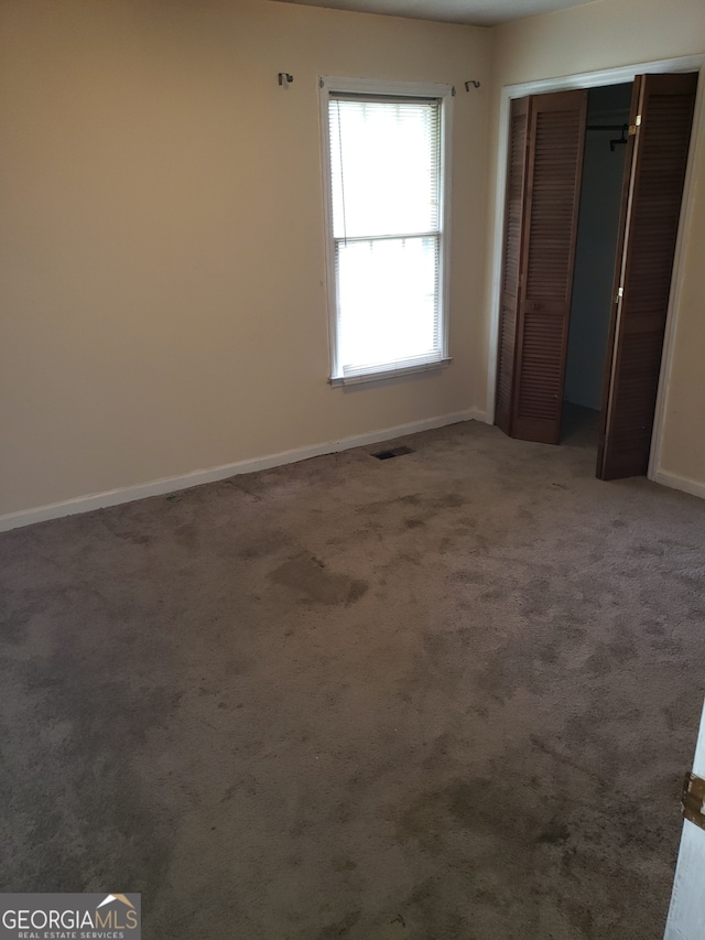 unfurnished bedroom featuring a closet and carpet