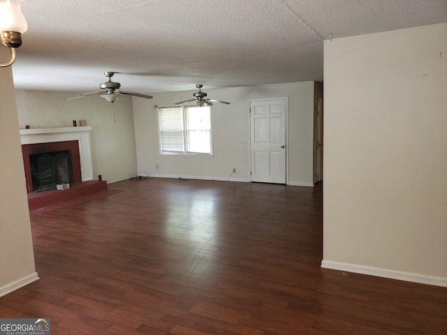 unfurnished living room featuring dark hardwood / wood-style floors, a textured ceiling, and ceiling fan