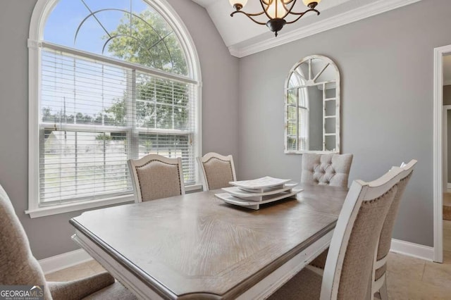 tiled dining area with lofted ceiling, a chandelier, crown molding, and plenty of natural light