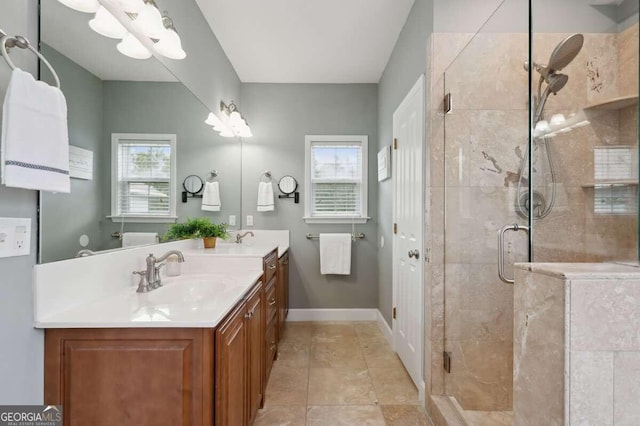 bathroom with vanity, a shower with shower door, and plenty of natural light