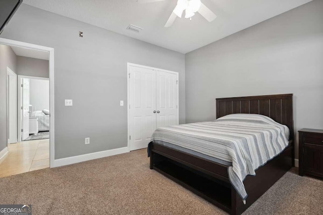 carpeted bedroom with a closet and ceiling fan