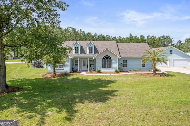 view of front of property with a front yard and a garage