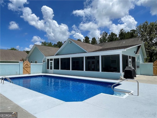 view of pool with a patio area and a sunroom