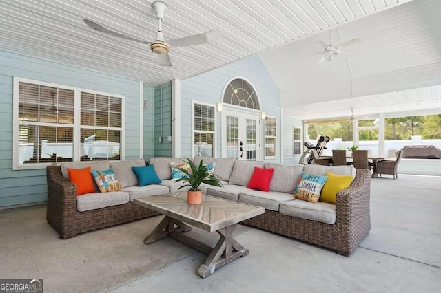 sunroom featuring lofted ceiling and ceiling fan