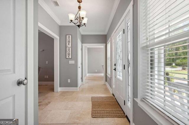 doorway featuring ornamental molding, a notable chandelier, and light tile patterned floors