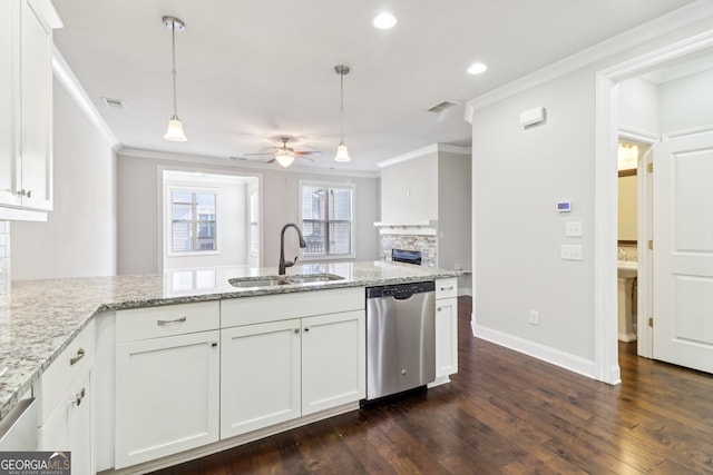 kitchen with sink, dishwasher, white cabinets, and hanging light fixtures