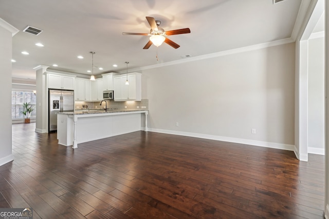 kitchen with white cabinetry, stainless steel appliances, hanging light fixtures, and dark hardwood / wood-style floors