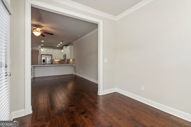 unfurnished living room featuring crown molding, ceiling fan, and dark hardwood / wood-style flooring