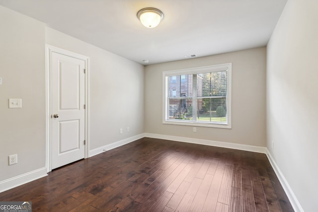 empty room featuring dark hardwood / wood-style flooring