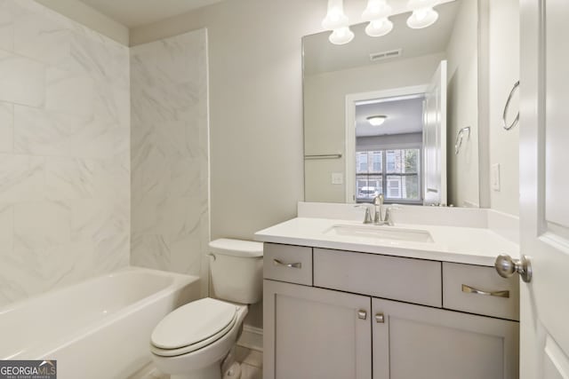 full bathroom with vanity, tiled shower / bath combo, and toilet