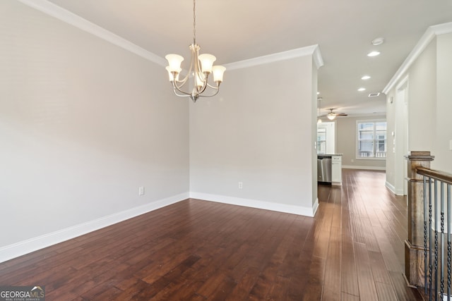 spare room with ornamental molding, dark hardwood / wood-style floors, and ceiling fan with notable chandelier