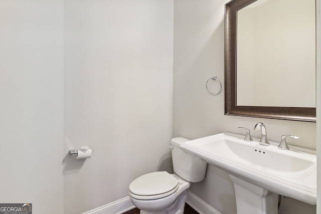 bathroom featuring sink and toilet